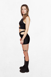 Model wearing an all-black top with a bold half-circle cutout under the bust. The elastic band creates a secure fit, while the design adds a daring, minimalist touch.