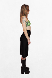 A green and black snake print crop top with silver carabiner closures. The form-fitting fabric and unique fastening details add an industrial touch to the bold, serpent-inspired design.