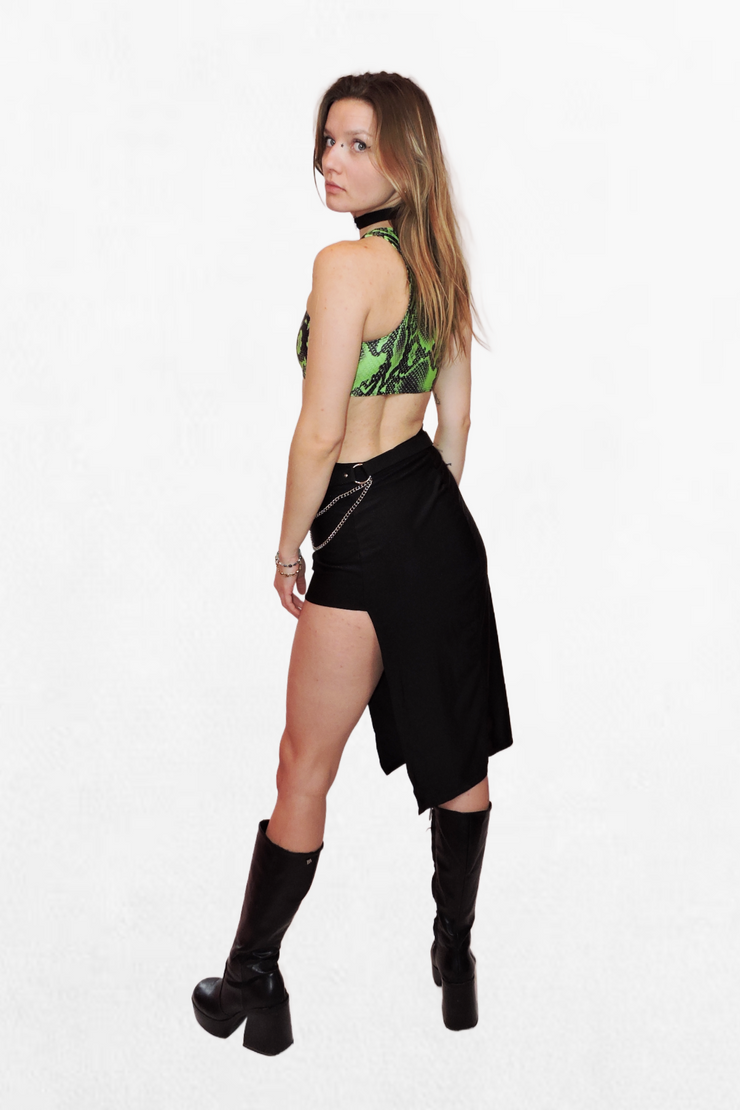 Model wearing a fitted green and black snake print crop top, secured with silver carabiner closures. The bold pattern and sleek fit make it a statement piece for any edgy look.