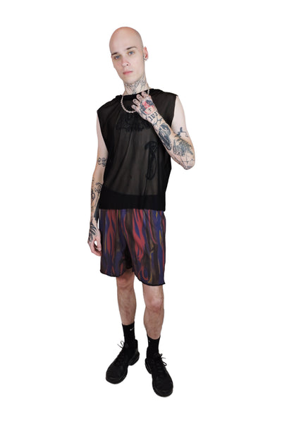 Loose-fitting red and purple men's shorts with an abstract pattern, designed for a bold rave style and ultimate comfort.